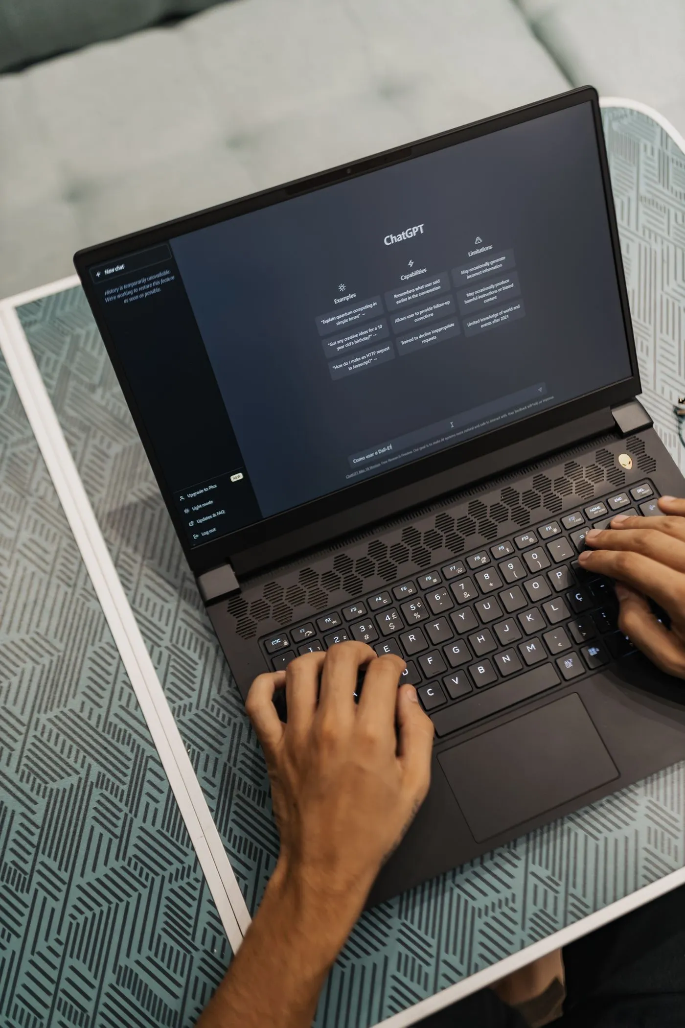Person exploring the ChatGPT interface on a laptop; illustrative stock photo