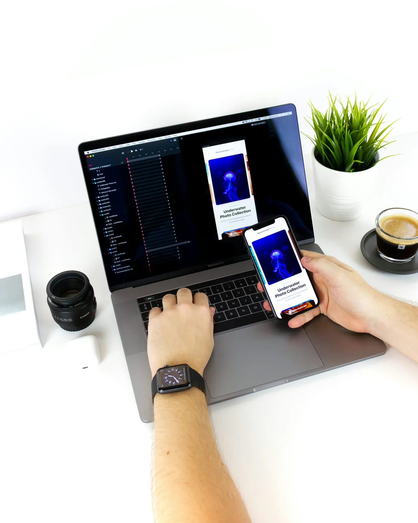 Hands comparing a smartphone interface with the matching laptop prototype